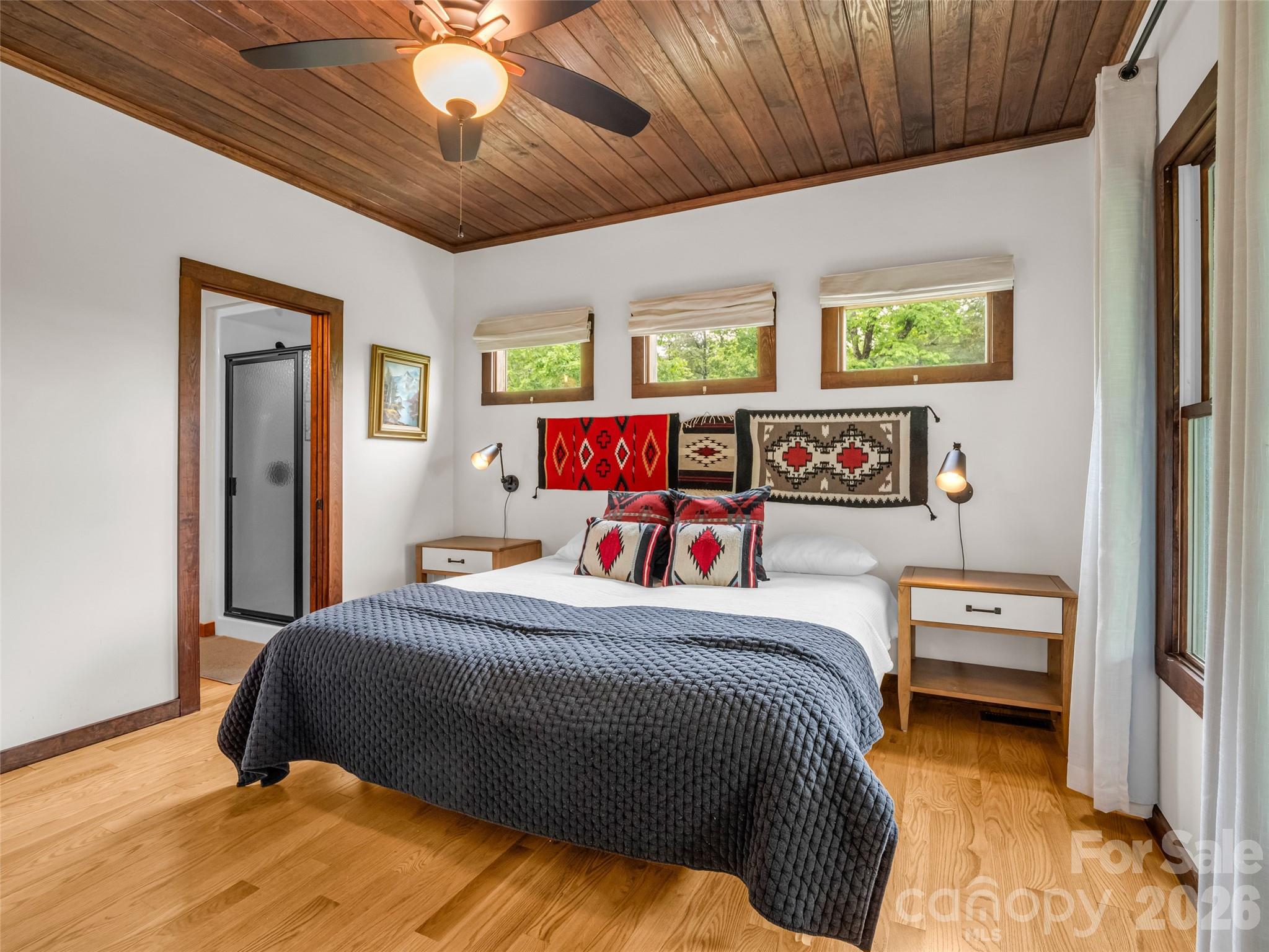 139 Picnic Point Road Lake Lure, NC 28746 - Photo 16 of 41 a bedroom with a bed and a chandelier
