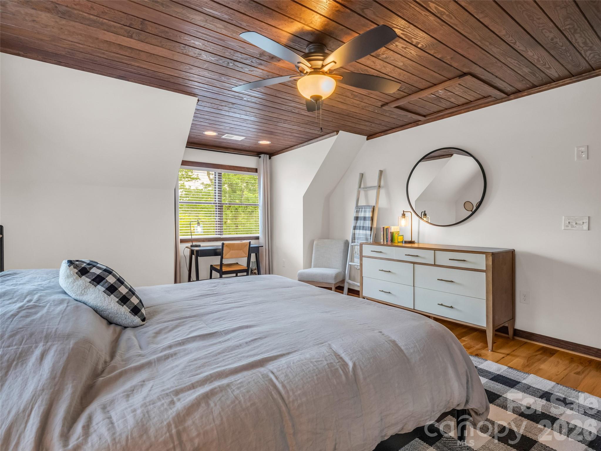139 Picnic Point Road Lake Lure, NC 28746 - Photo 21 of 41 a bedroom with a bed a dresser and a window