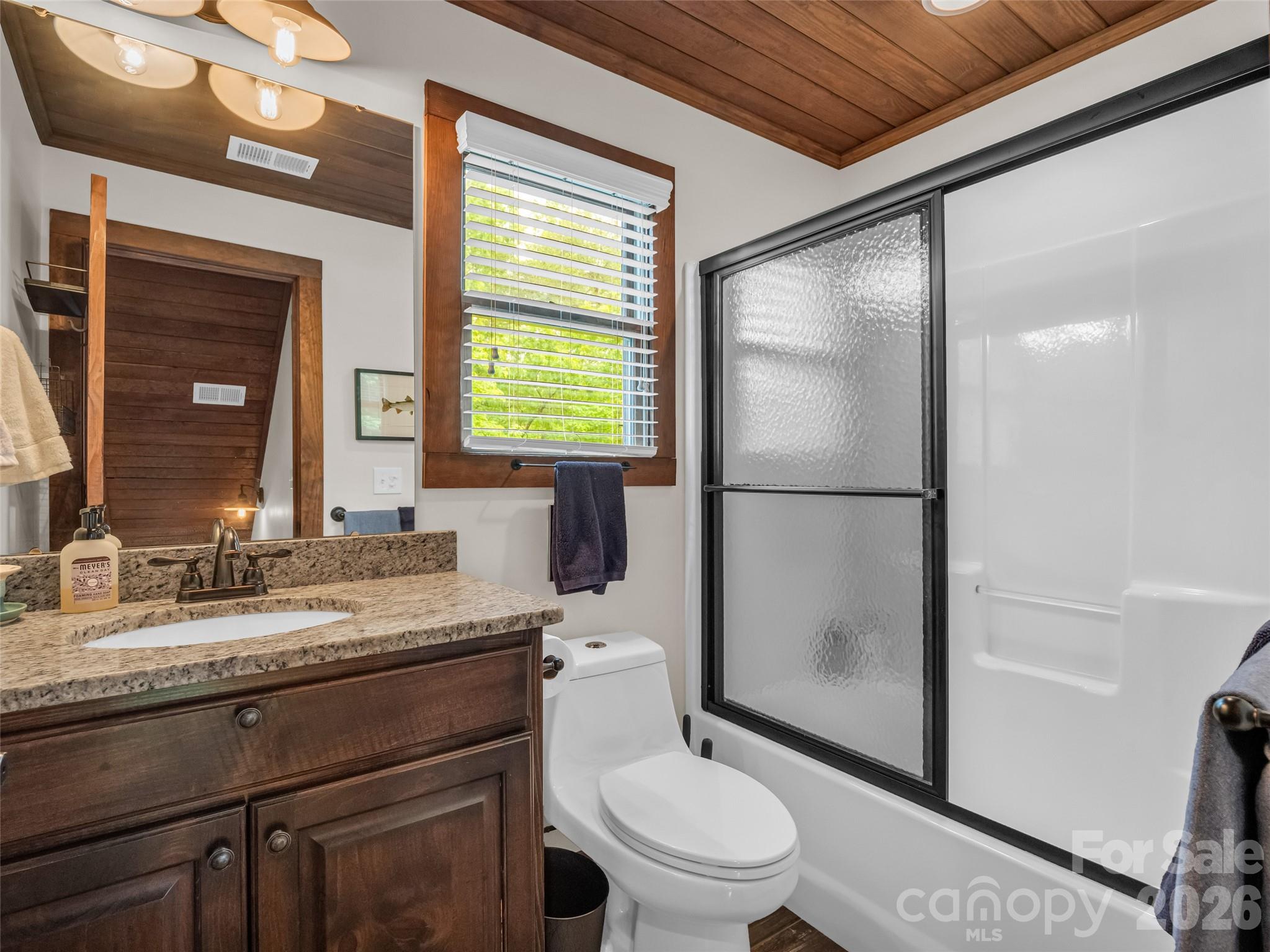 139 Picnic Point Road Lake Lure, NC 28746 - Photo 22 of 41 a bathroom with a granite countertop sink toilet and shower