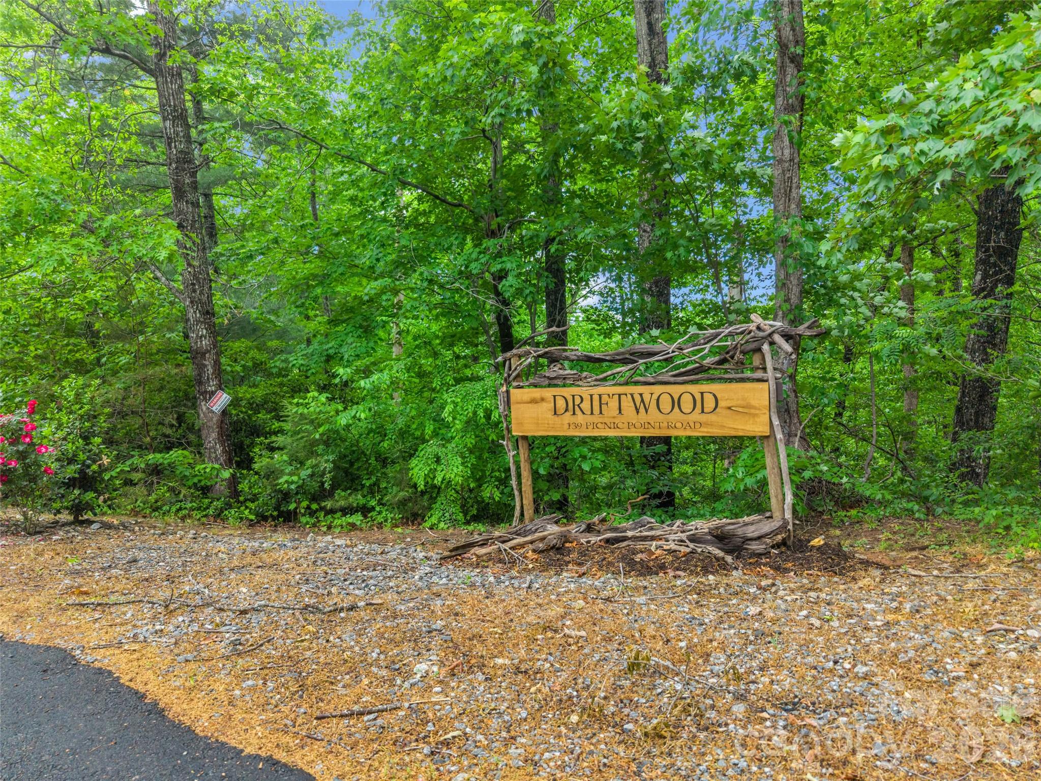 139 Picnic Point Road Lake Lure, NC 28746 - Photo 4 of 41 a sign board with a bench and trees