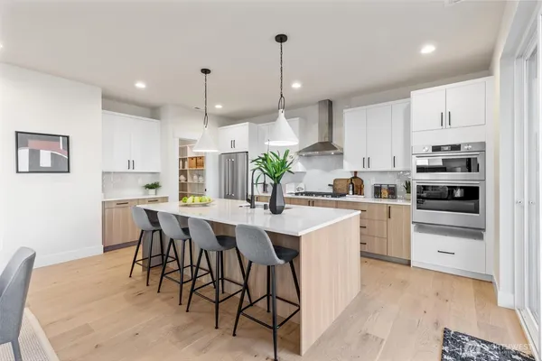 a kitchen with kitchen island white cabinets and white appliances