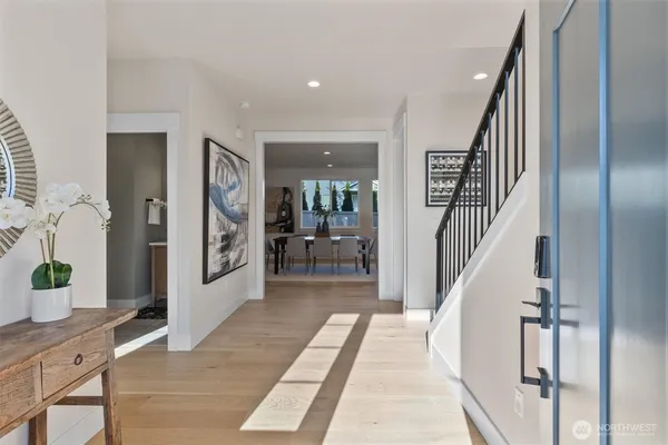 a view of a hallway with wooden floor and windows