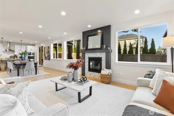 a living room with furniture fireplace and window