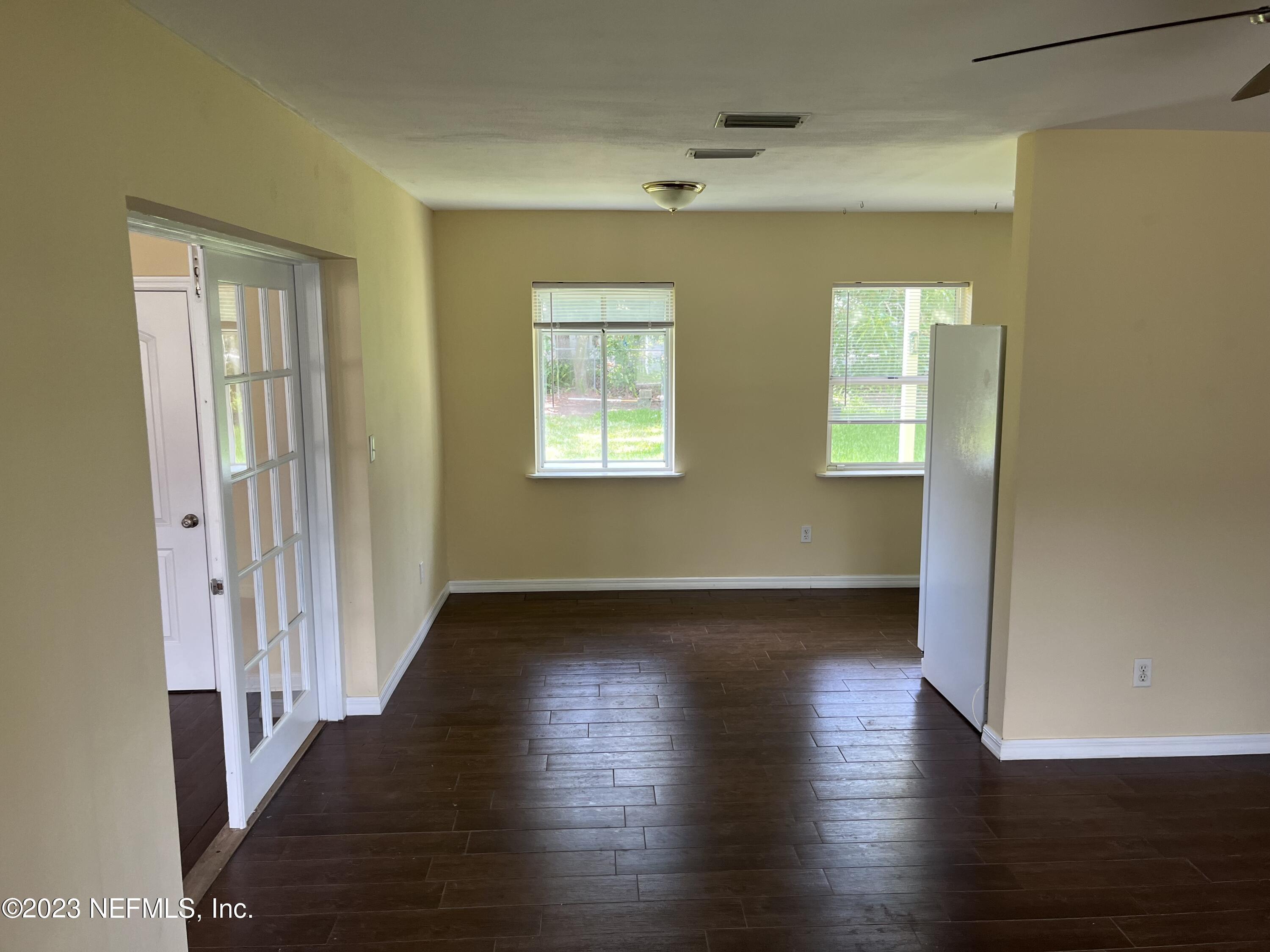 5418 Juno Drive Jacksonville, FL 32207 - Photo 4 of 19 a view of an empty room with wooden floor and a window