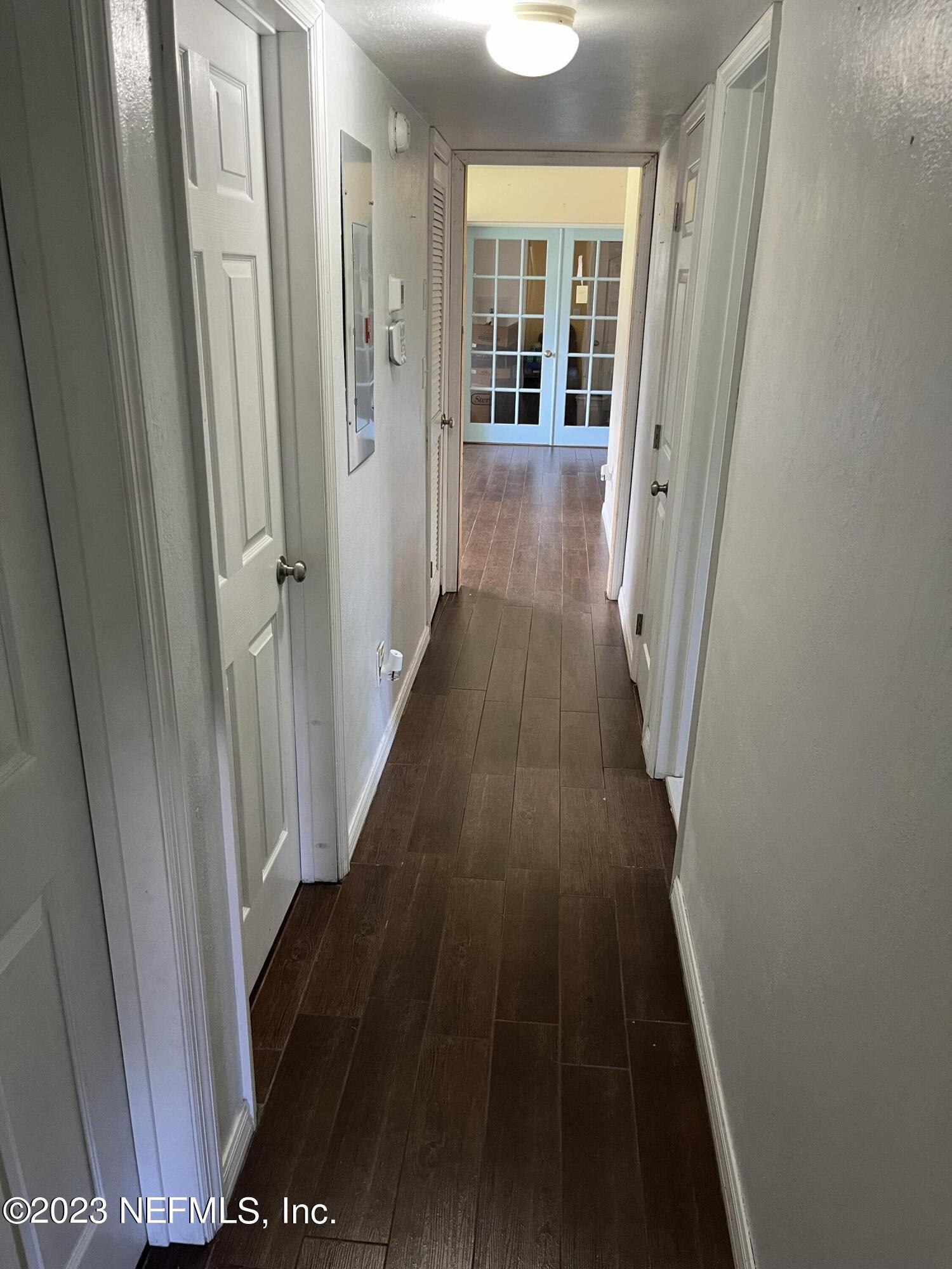 5418 Juno Drive Jacksonville, FL 32207 - Photo 10 of 19 a view of a hallway with wooden floor and staircase