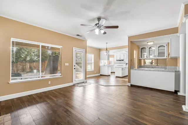 an empty room with a ceiling fan and a window