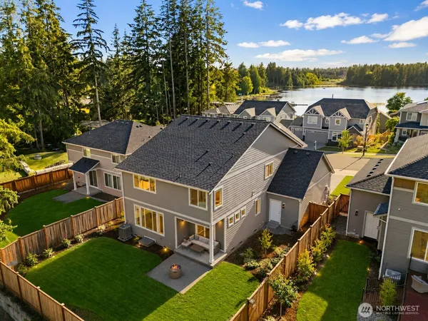 an aerial view of a house with outdoor space and lake view