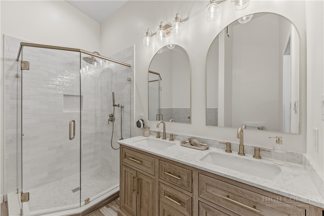 355 South River Hills Road Lansing, NC 28643 - Photo 29 of 45 a bathroom with a double vanity sink mirror and shower
