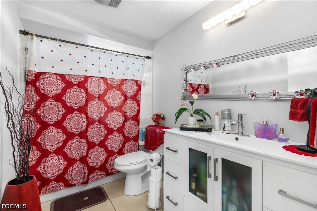 18 Illinois Road Lehigh Acres, FL 33936 - Photo 24 of 45 a bathroom with a sink toilet and a mirror