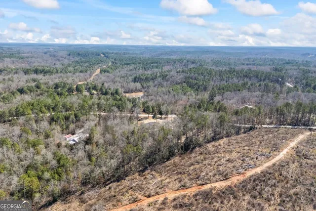 a kitchen with granite countertop white cabinets and a window