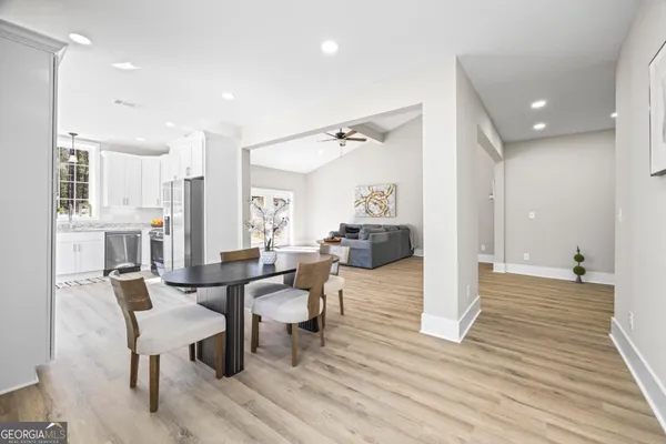 a spacious bedroom with two beds a chandelier and a window