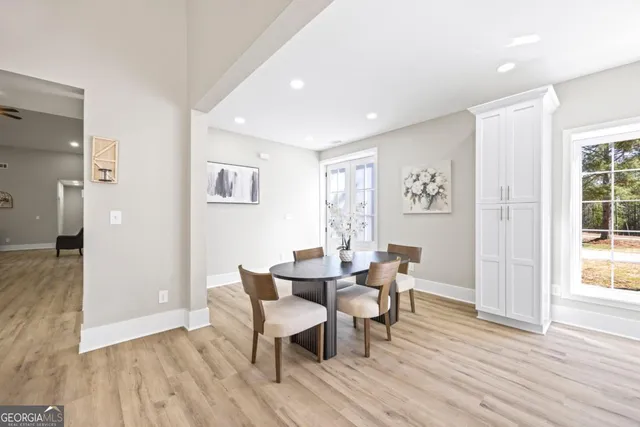 a view of a small space with wooden floor and a window