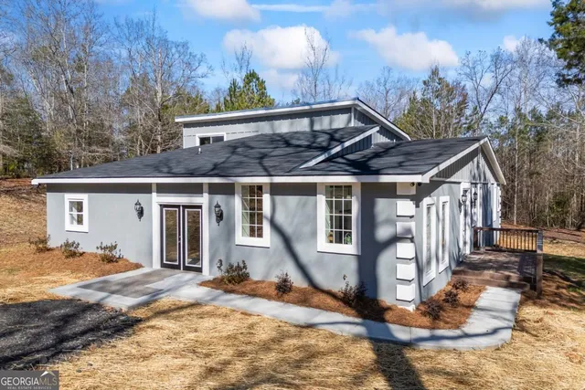 a white house with trees in front of it