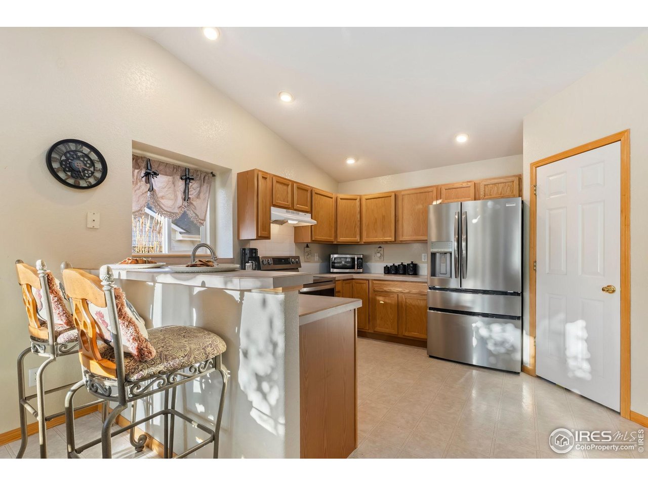 623 Foxtail Way Severance, CO 80550 - Photo 12 of 27 a kitchen with stainless steel appliances granite countertop a refrigerator and a stove top oven