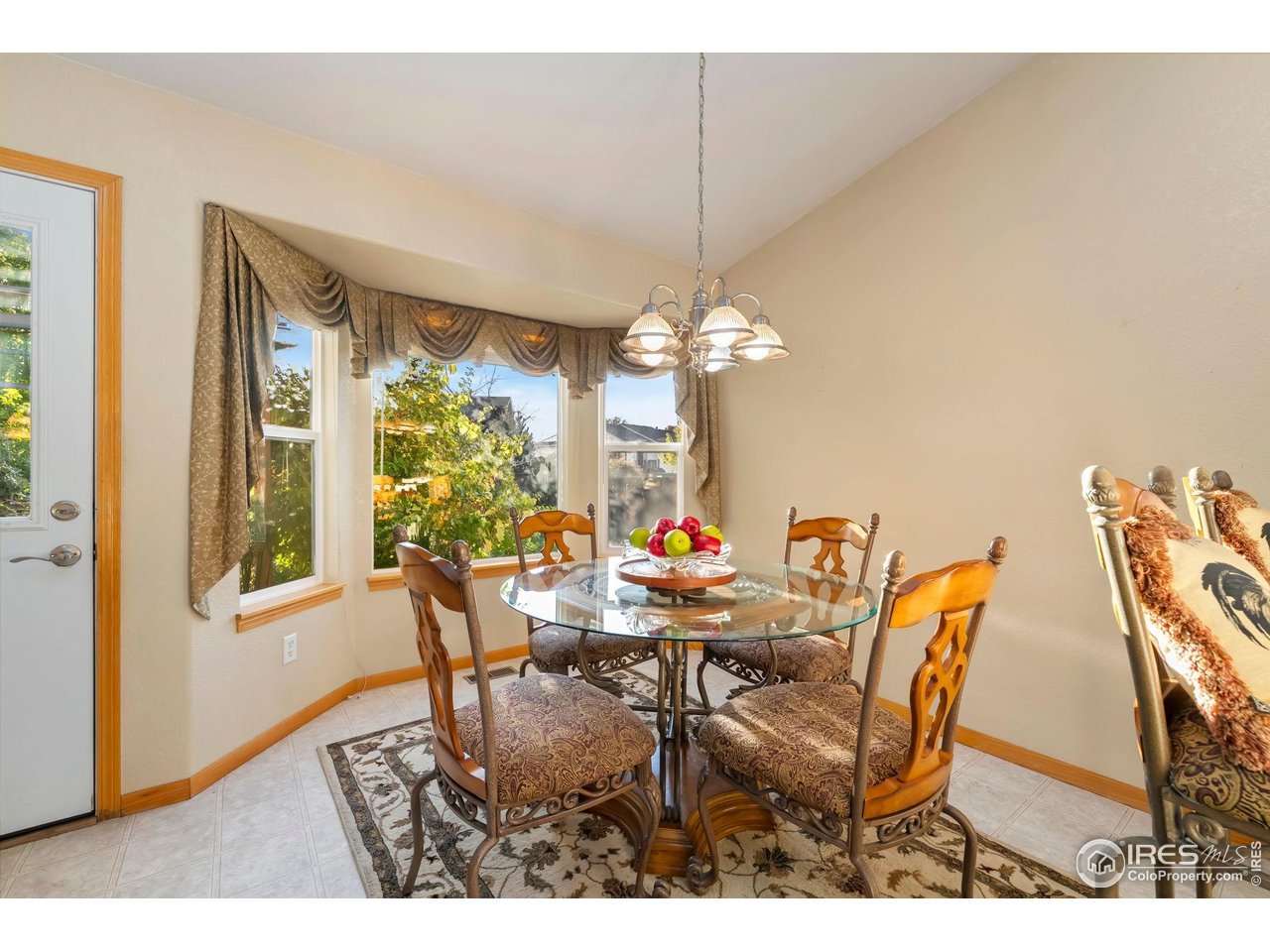 623 Foxtail Way Severance, CO 80550 - Photo 14 of 27 a dining room with furniture a chandelier and window
