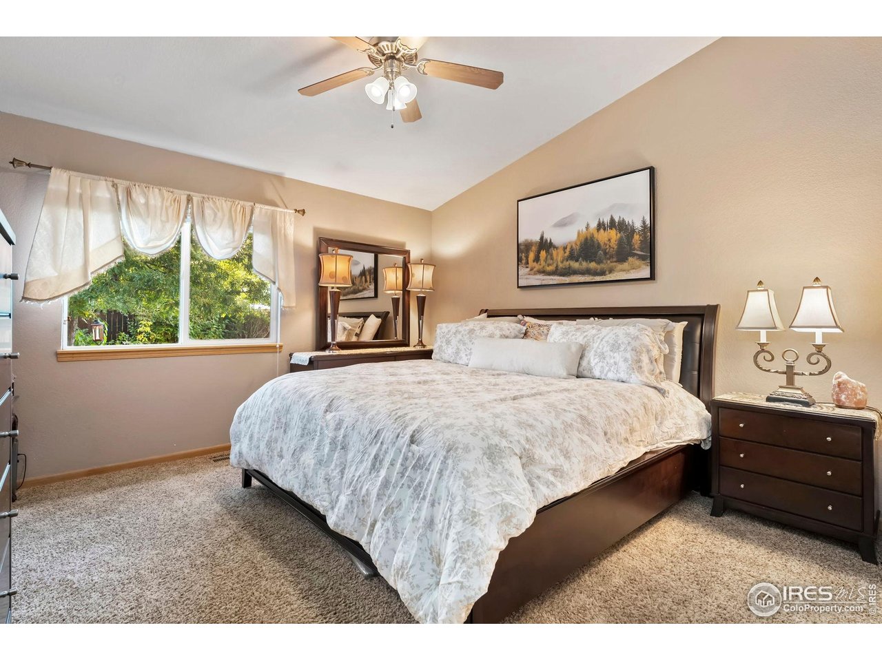 623 Foxtail Way Severance, CO 80550 - Photo 17 of 27 a bedroom with a bed painting on the wall and a large window