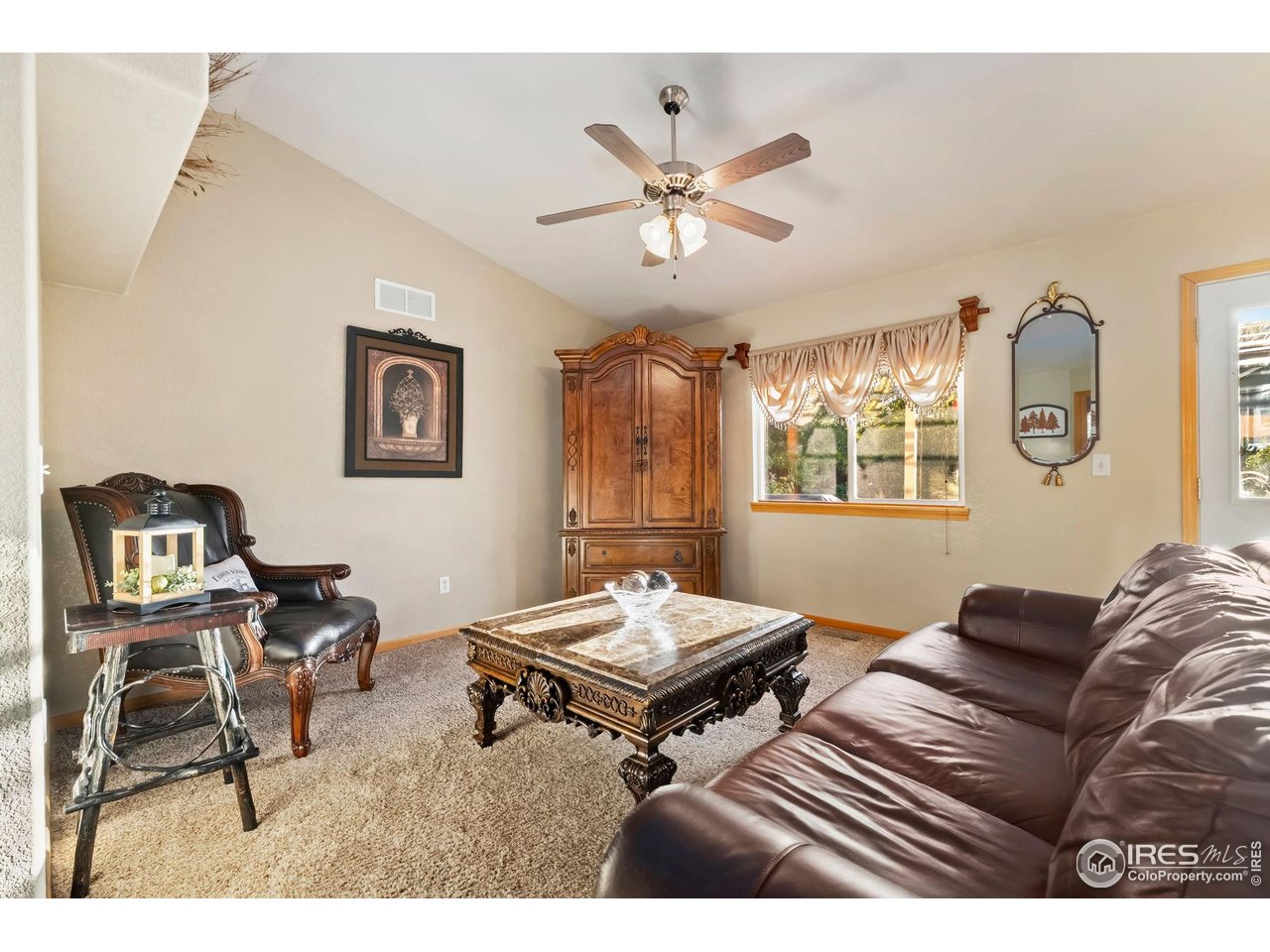623 Foxtail Way Severance, CO 80550 - Photo 8 of 27 a living room with furniture a rug and a window