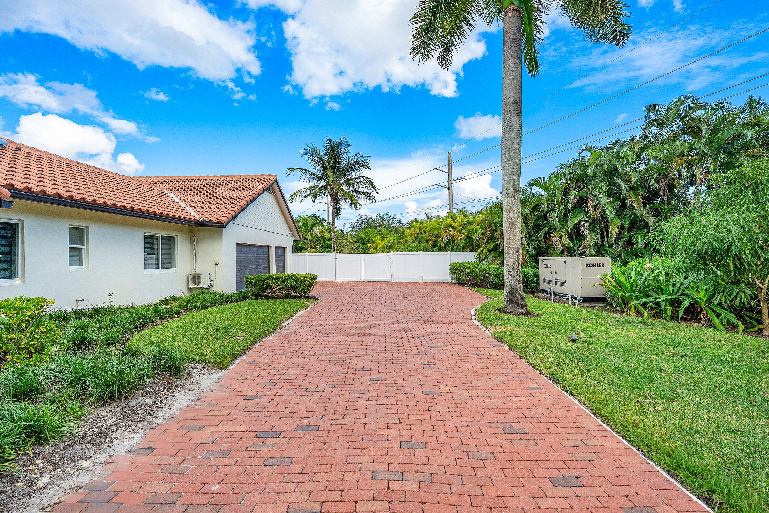6641 Giralda Circle Boca Raton, FL 33433 - Photo 116 of 116 a front view of a house with a yard and potted plants
