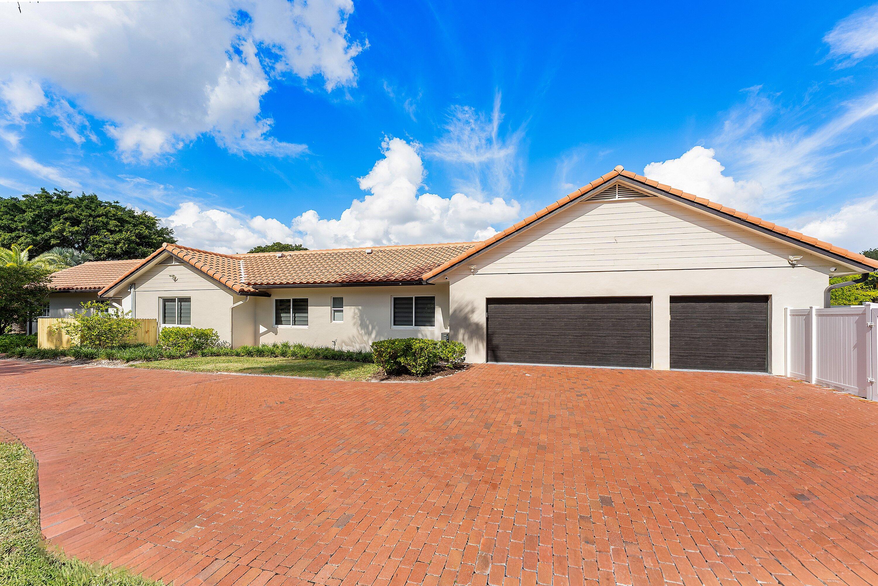 6641 Giralda Circle Boca Raton, FL 33433 - Photo 12 of 116 a front view of a house with a yard and garage