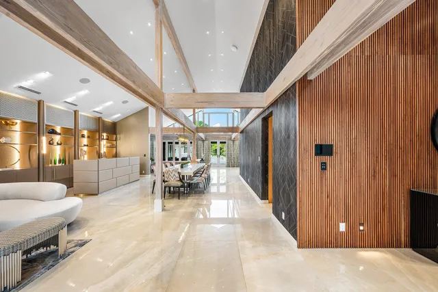 a dining room with furniture and a large window