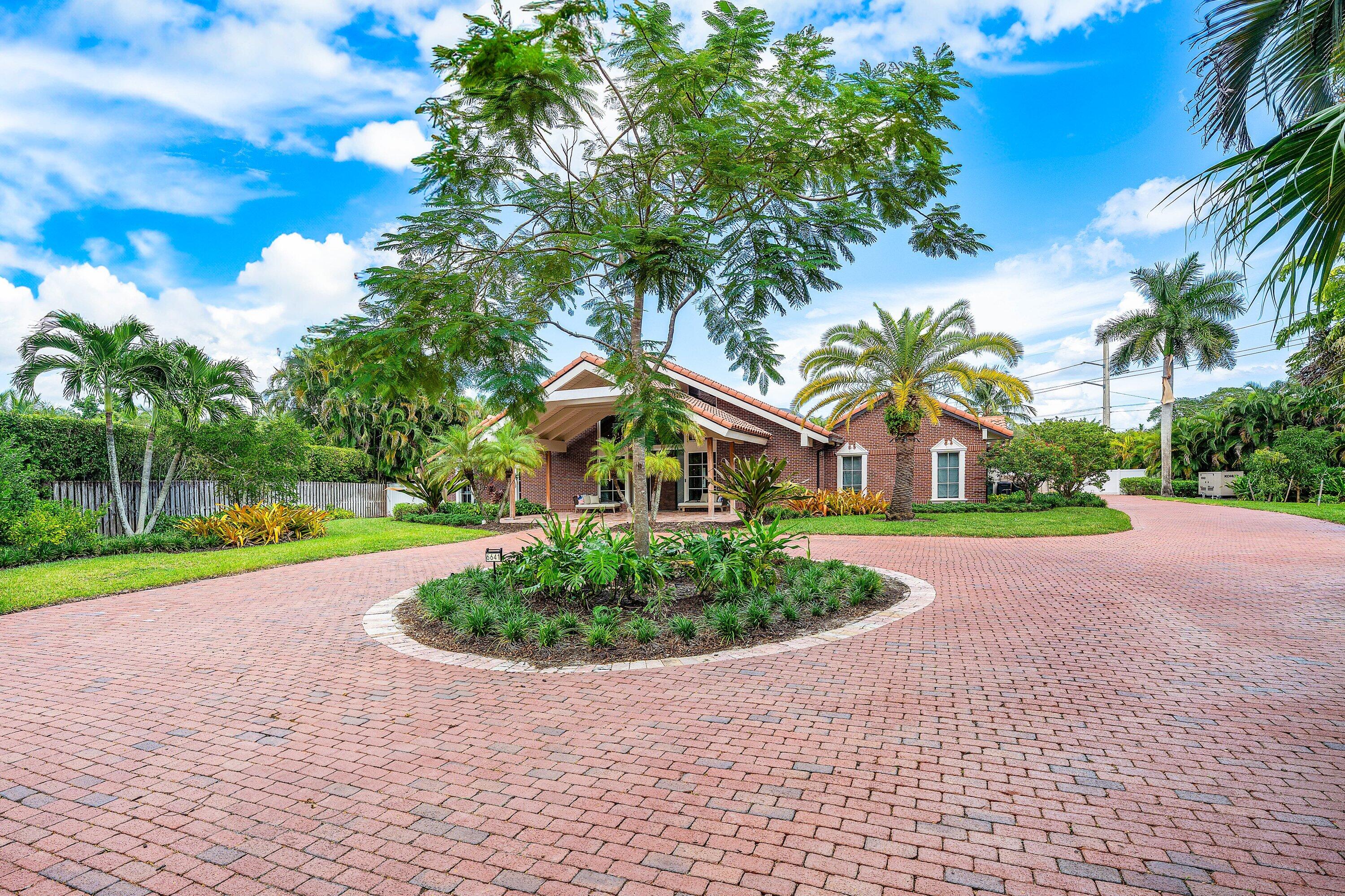 6641 Giralda Circle Boca Raton, FL 33433 - Photo 2 of 116 a front view of a house with garden and trees