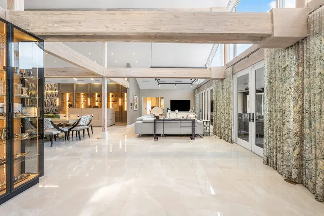 a living room with furniture and a bookshelf