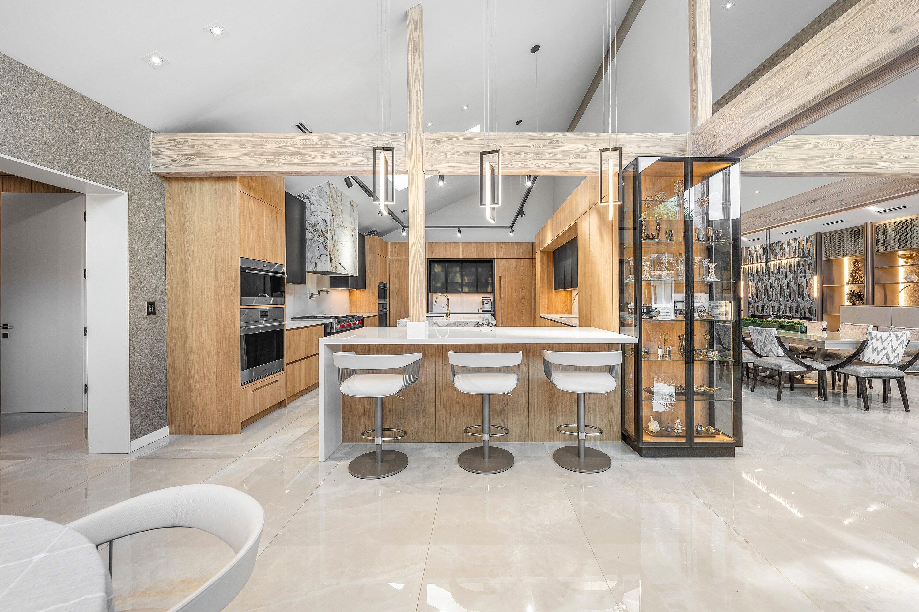 6641 Giralda Circle Boca Raton, FL 33433 - Photo 28 of 116 a kitchen with stainless steel appliances kitchen island granite countertop a table and chairs