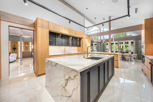 a bathroom with a double vanity sink mirror and shower