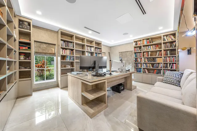 a front view of a house with a yard and potted plants