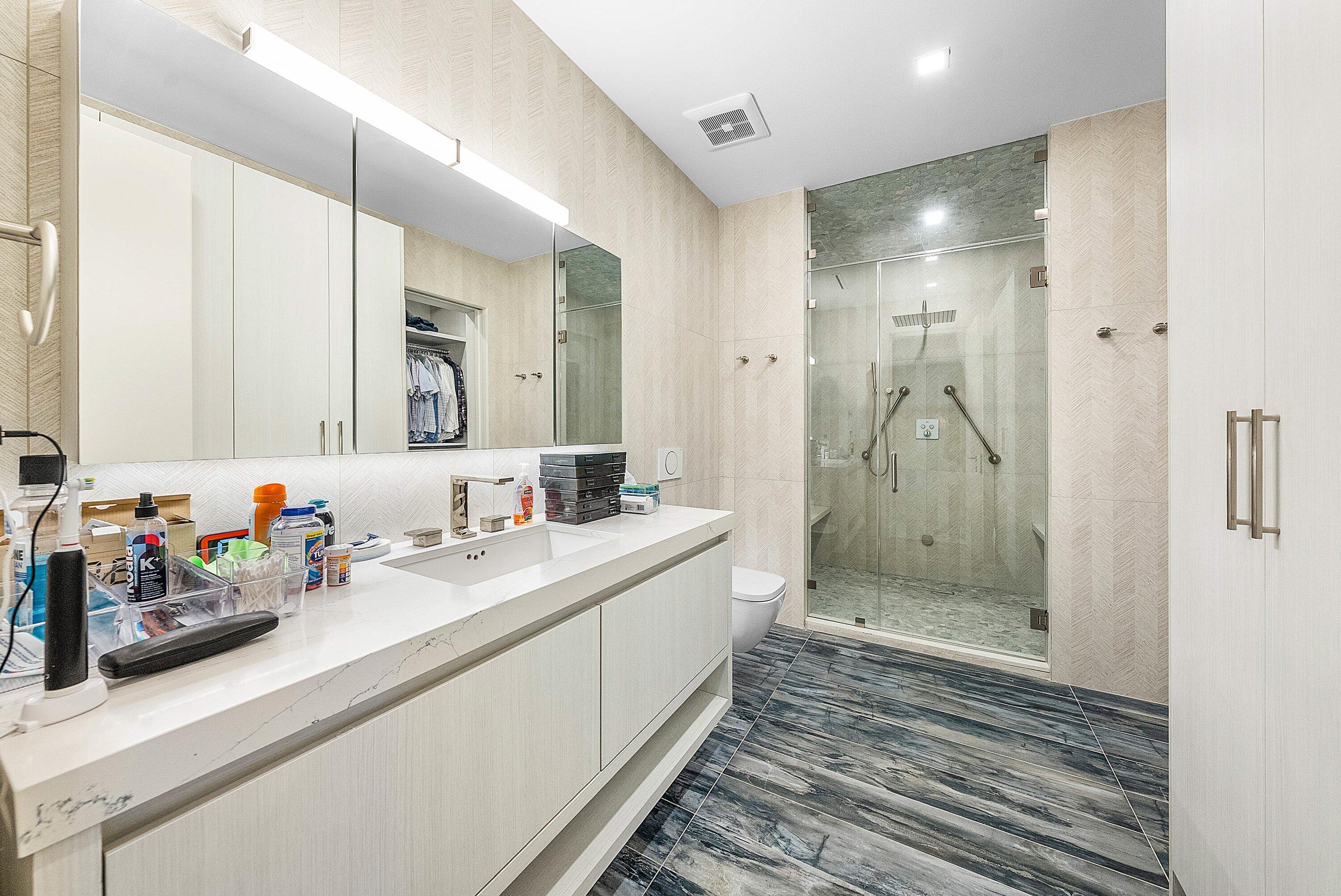 6641 Giralda Circle Boca Raton, FL 33433 - Photo 57 of 116 a bathroom with a double vanity sink mirror and shower