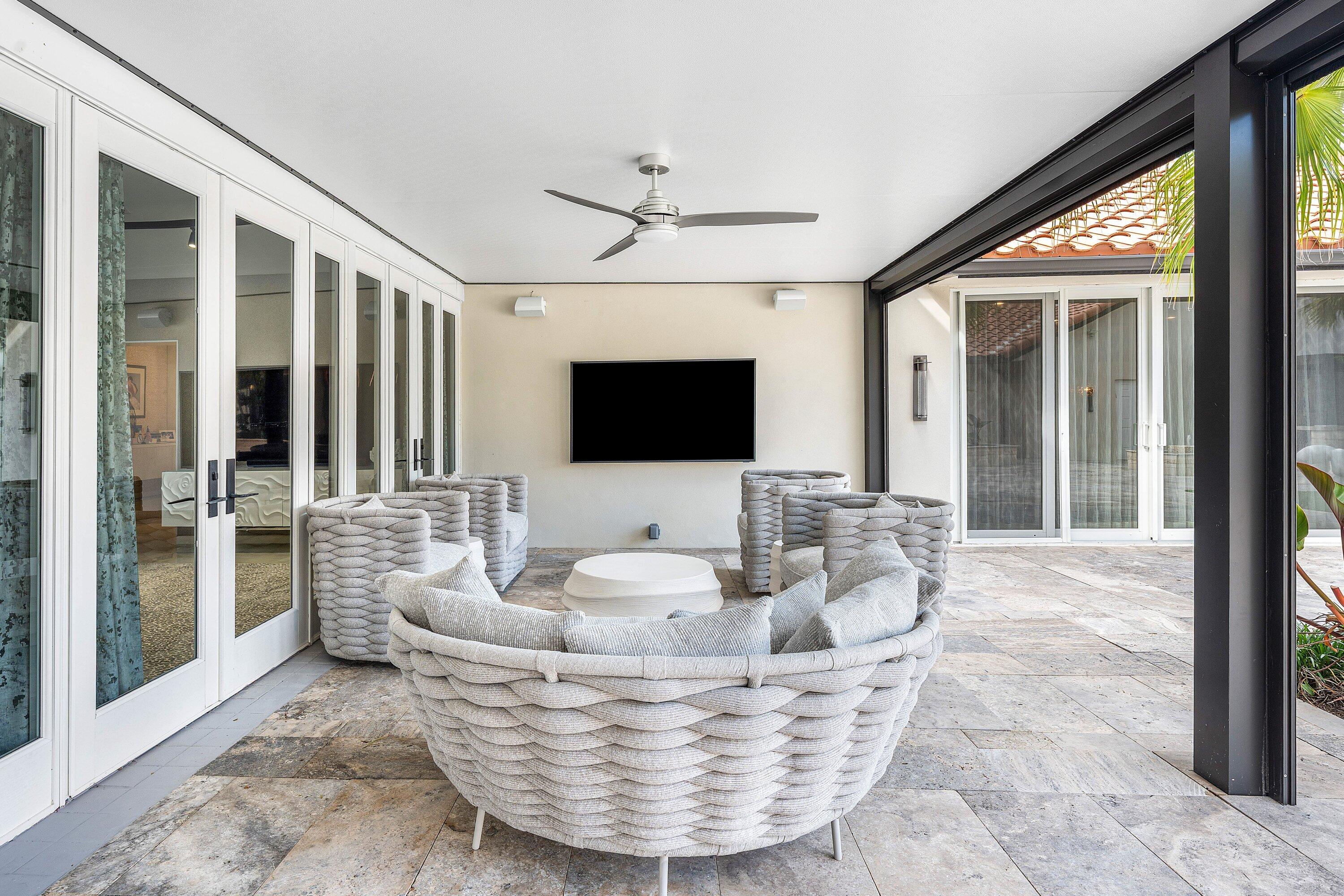 6641 Giralda Circle Boca Raton, FL 33433 - Photo 67 of 116 a living room with couches a flat screen tv and a fireplace