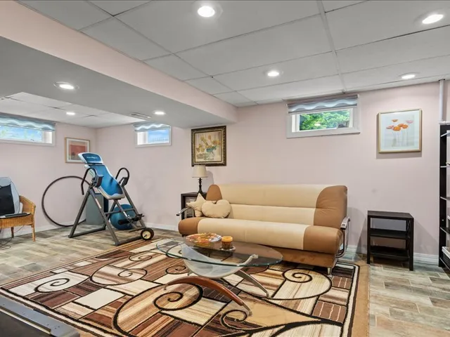 a living room with furniture a bike and a table