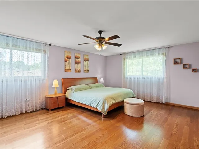 a spacious bedroom with a bed and a window