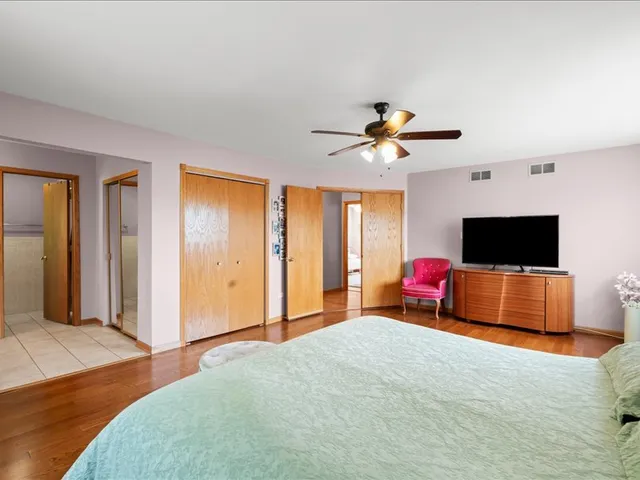 a bedroom with furniture and a flat screen tv