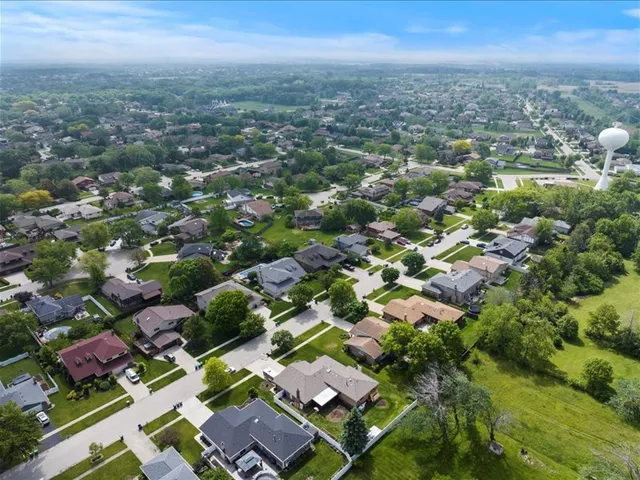 an aerial view of residential houses with city view