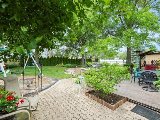 a view of a chair and table in the garden
