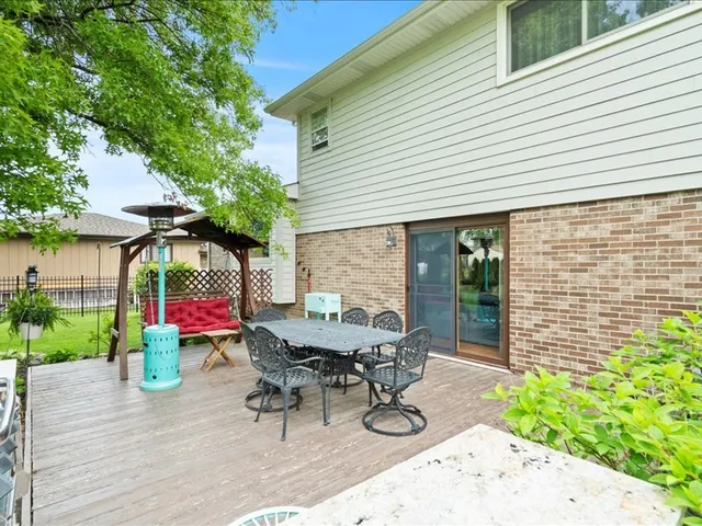 a view of a patio with table and chairs and potted plants