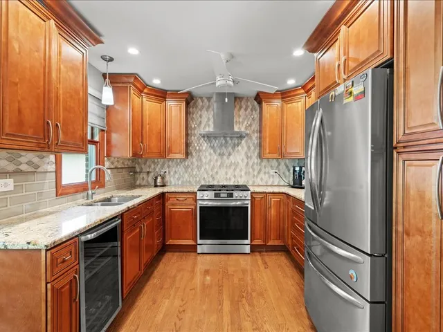 a kitchen with stainless steel appliances granite countertop a refrigerator and a sink