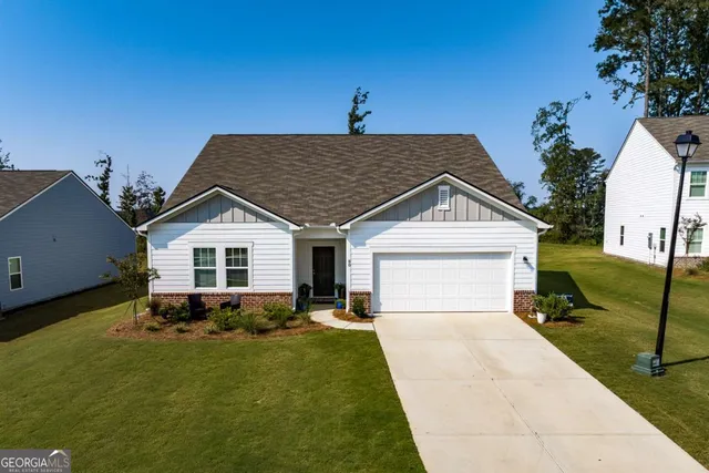 a front view of house with yard and green space