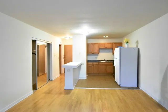a view of kitchen with a sink cabinets and stainless steel appliances