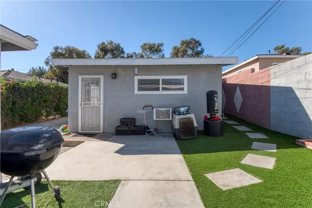 a backyard of a house with table and chairs