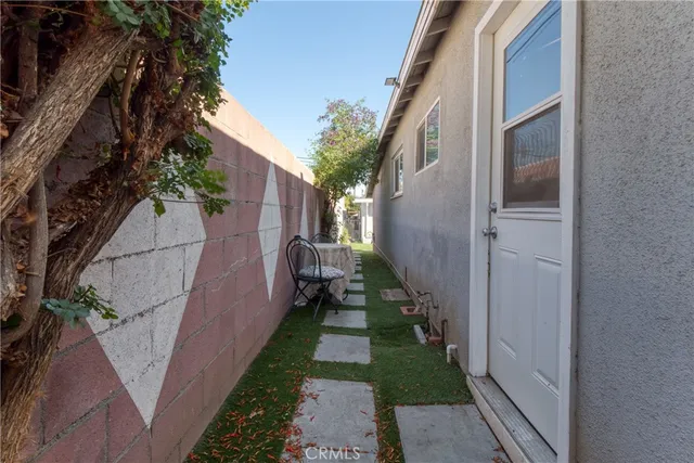 a view of a pathway of a house with a yard
