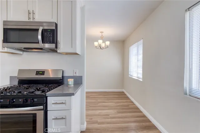a kitchen with stainless steel appliances a stove a microwave and cabinets