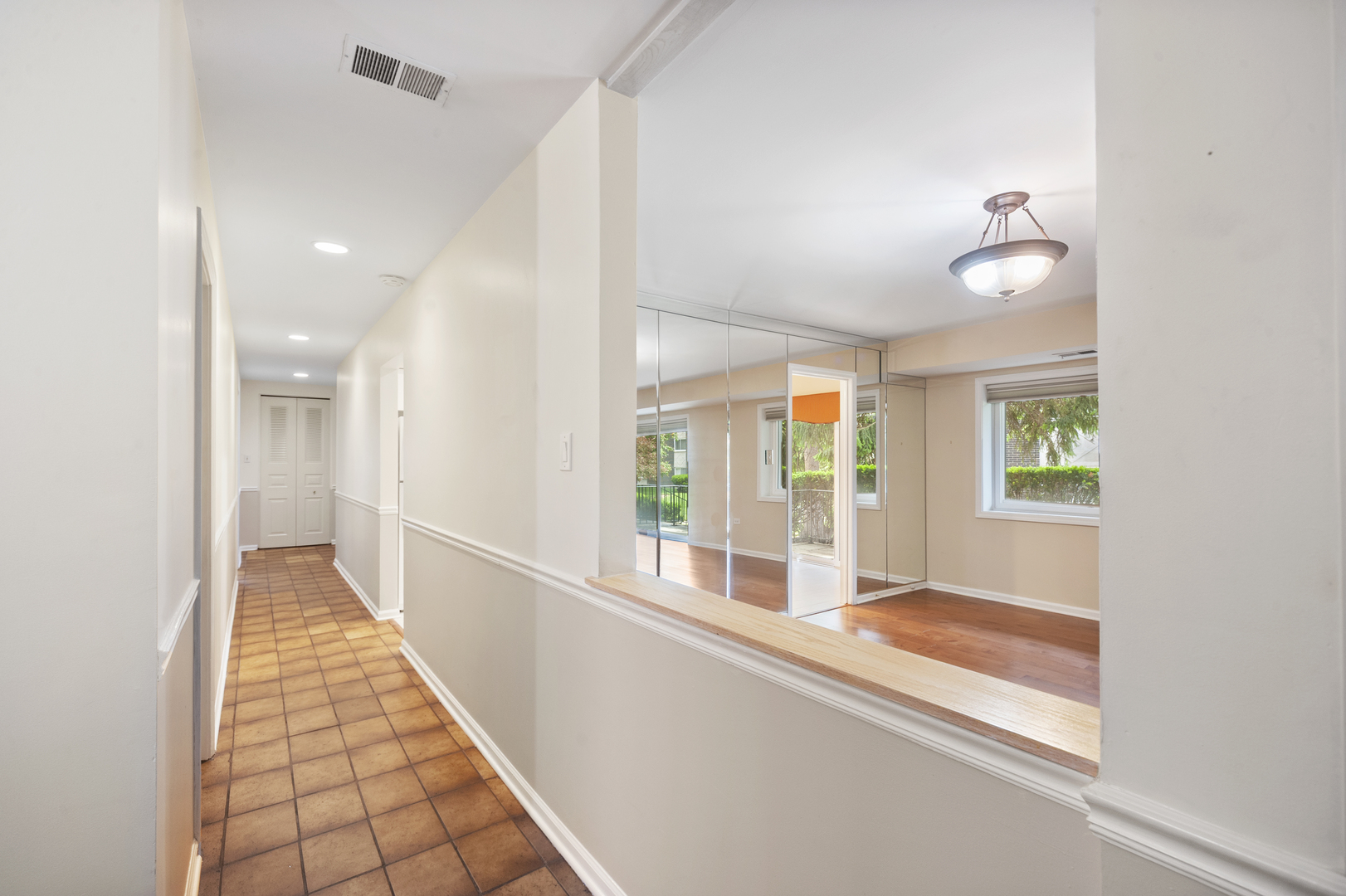 4949 Golf Road, Unit 101 Skokie, IL 60077 - Photo 4 of 22 a view of a hallway with windows