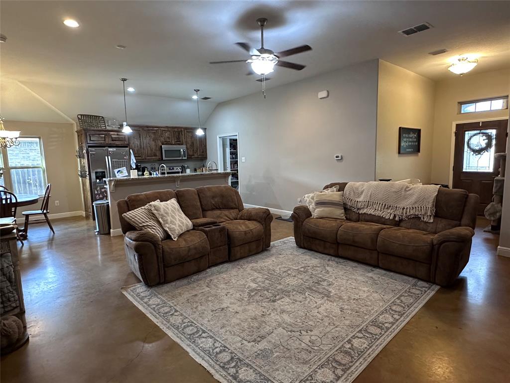 1212 Bowman Ridge Road Stephenville, TX 76401 - Photo 5 of 23 a living room with furniture kitchen view and a table