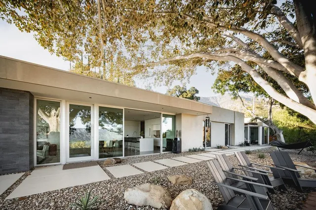 a view of a house with backyard porch and sitting area