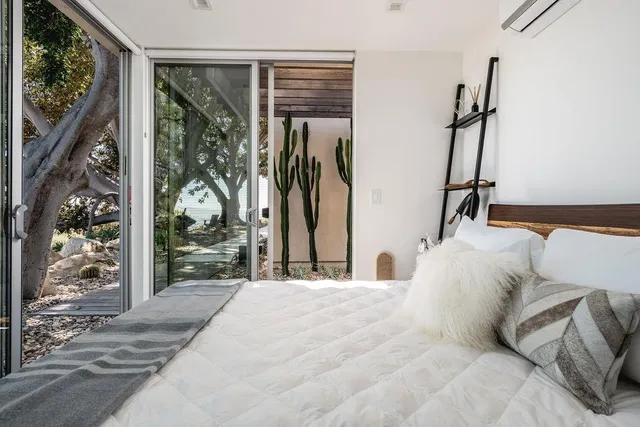 a bedroom with a bed and a large window