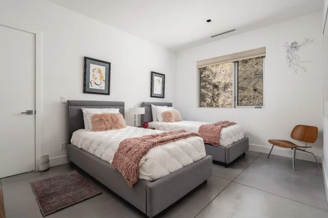 a bedroom with bed and a chair