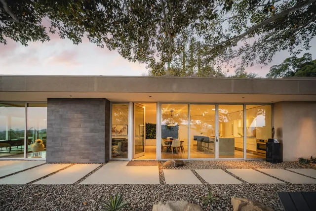 a backyard of a house with table and chairs