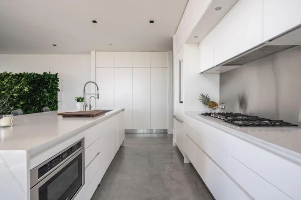 a kitchen with stainless steel appliances a sink stove and cabinets